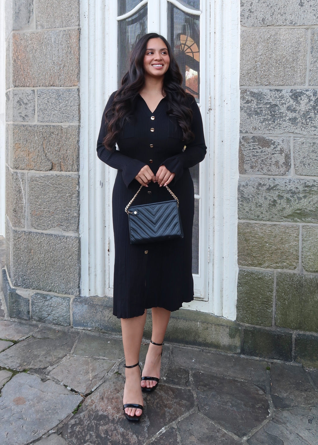 Black sweater dress, gold buttons, cuff sleeves, midi length, v-neck, collar