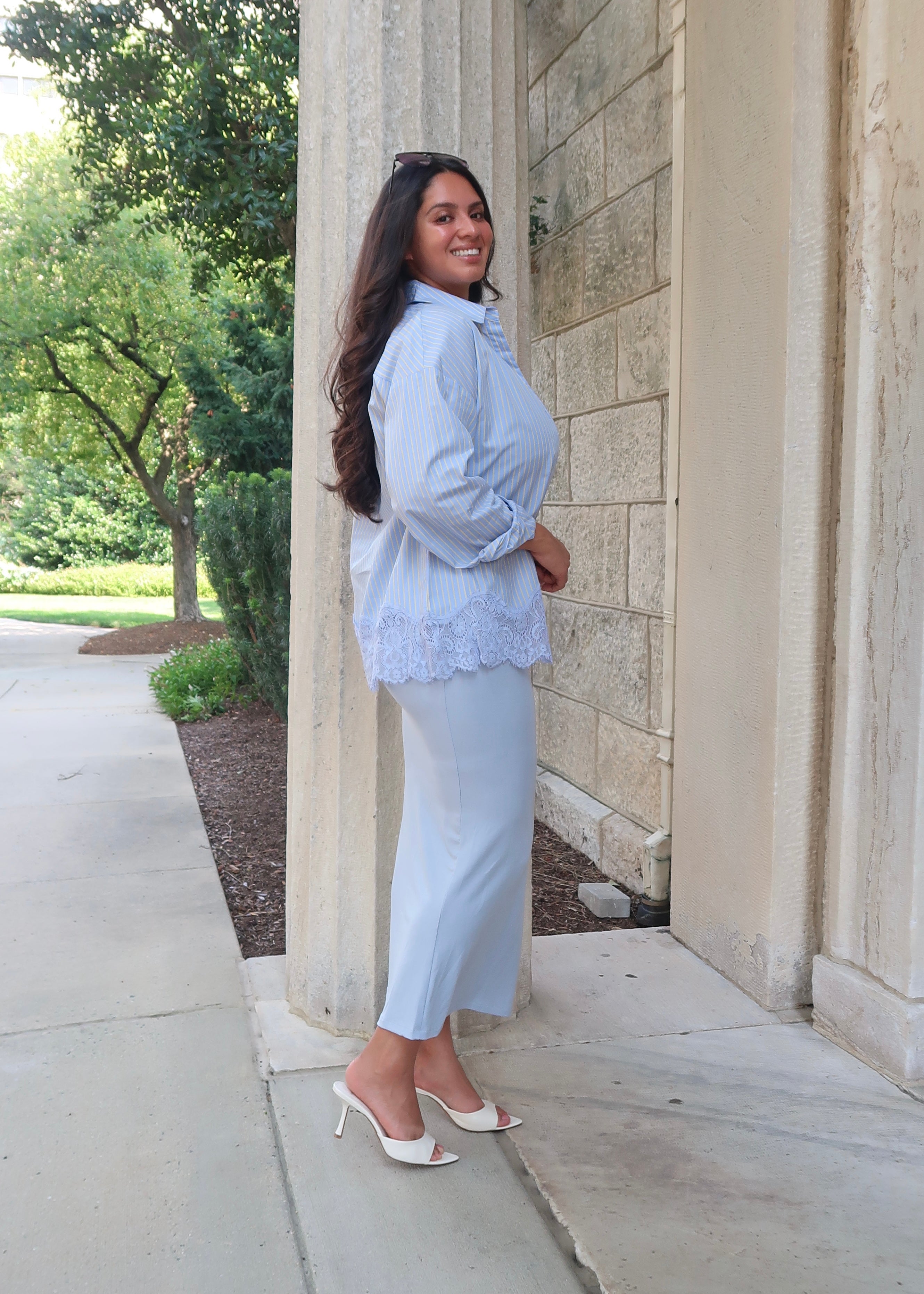Blue and yellow pinstripe womens button down blouse, collared, lace hem, long sleeves, baby blue dress underneath, white heels 