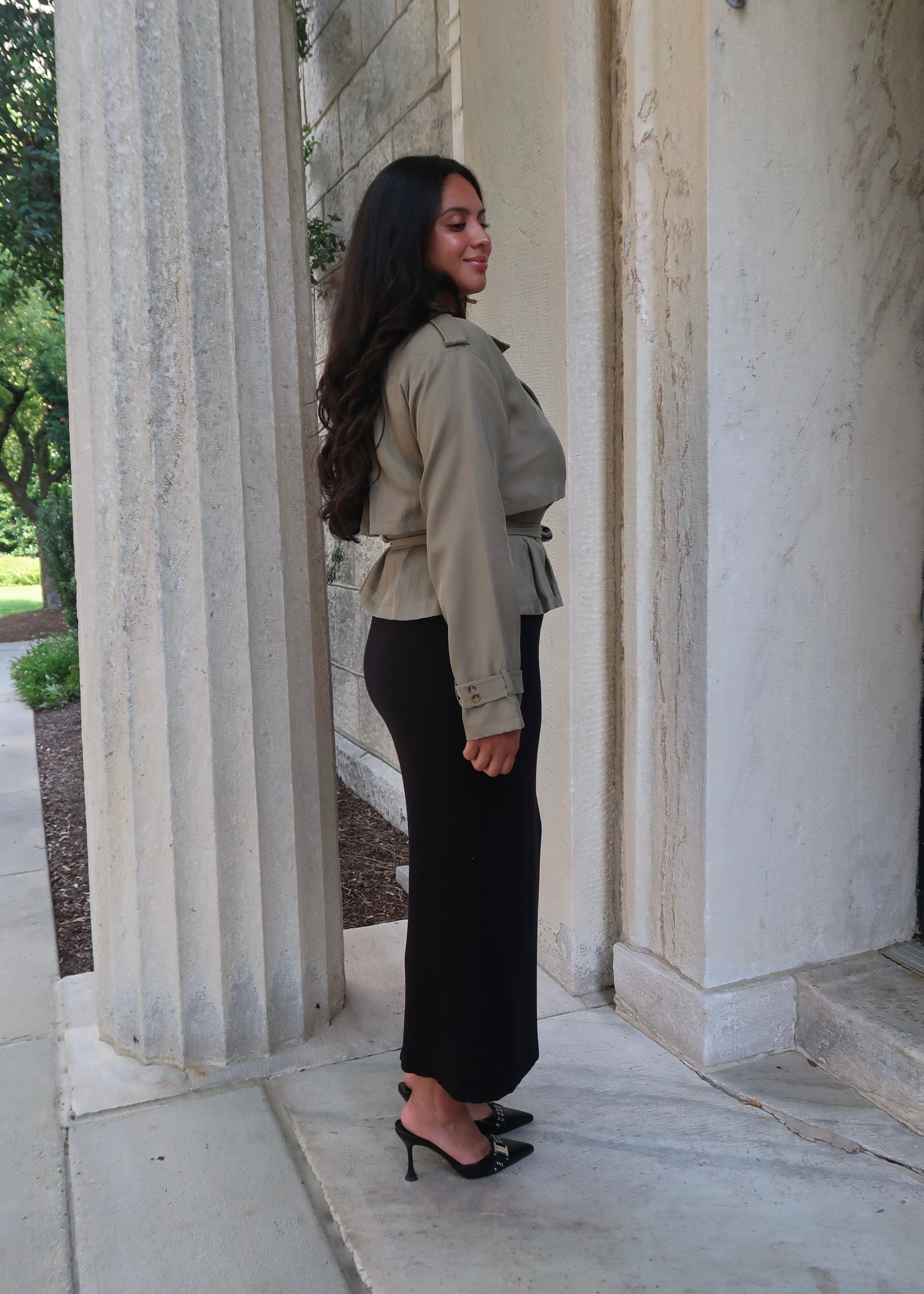 Olive green cropped waist tie trench jacket with black skirt and buckled heels