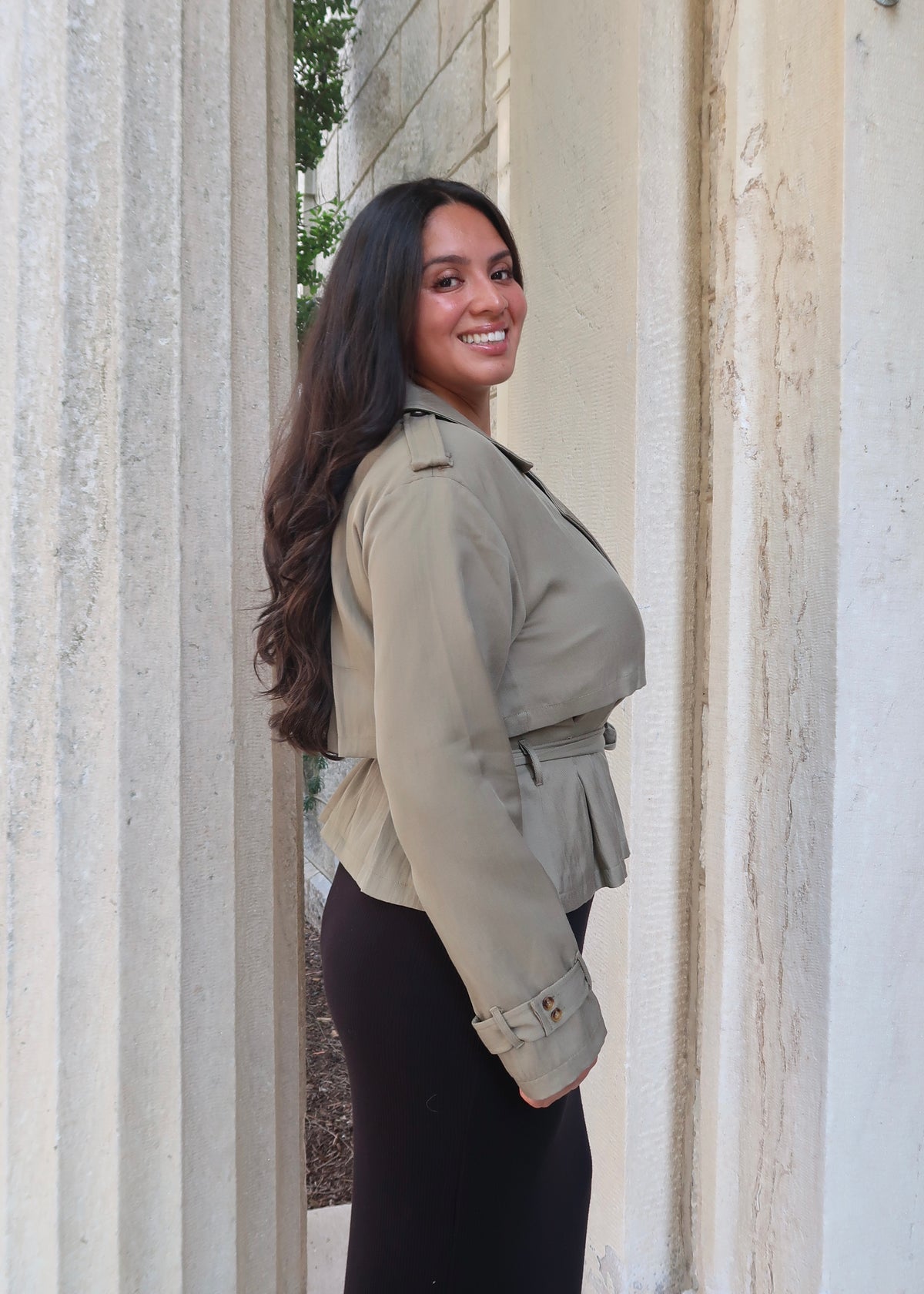 Olive green cropped waist tie trench jacket with black skirt and buckled heels