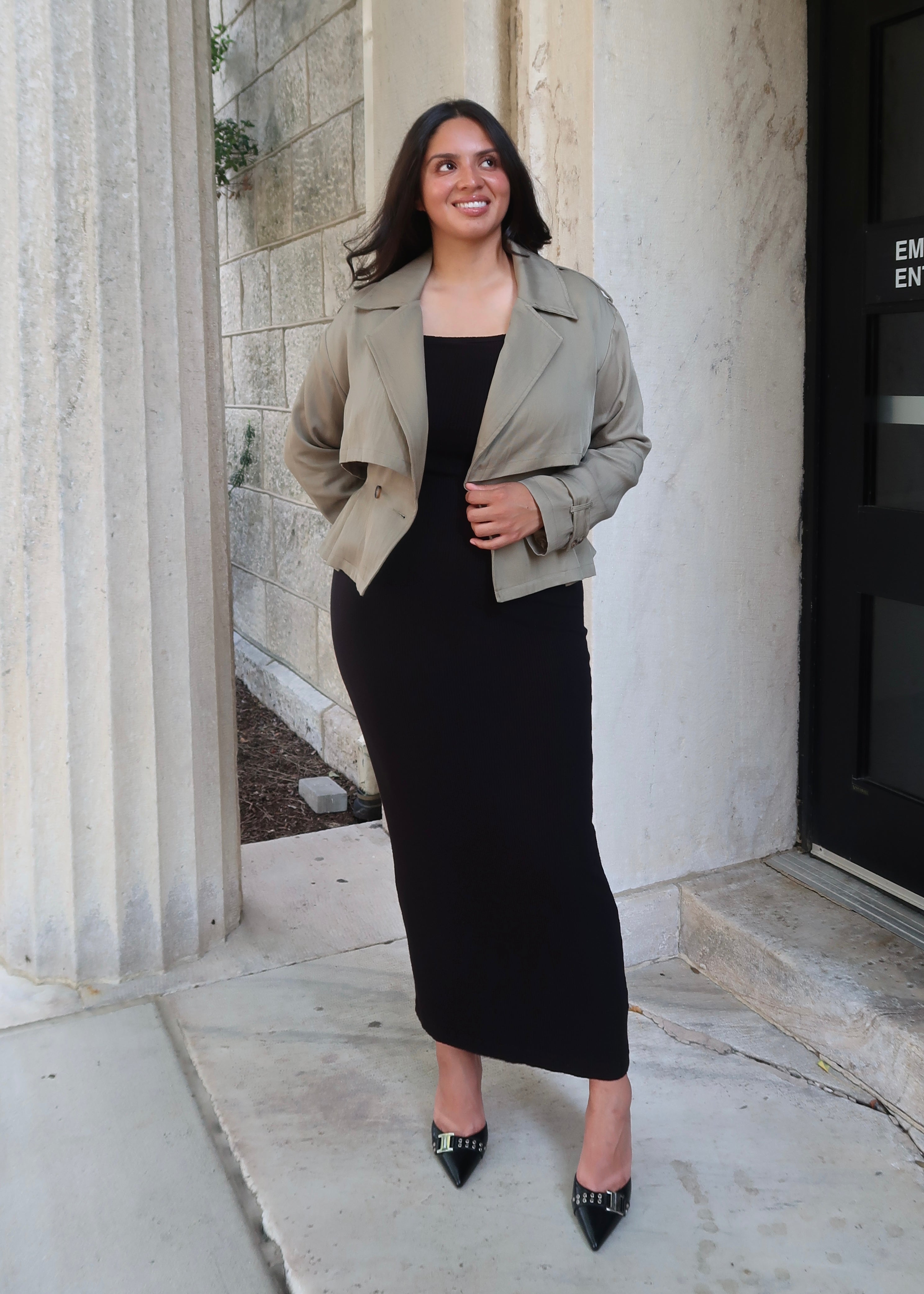 Olive green cropped waist tie trench jacket with black skirt and buckled heels
