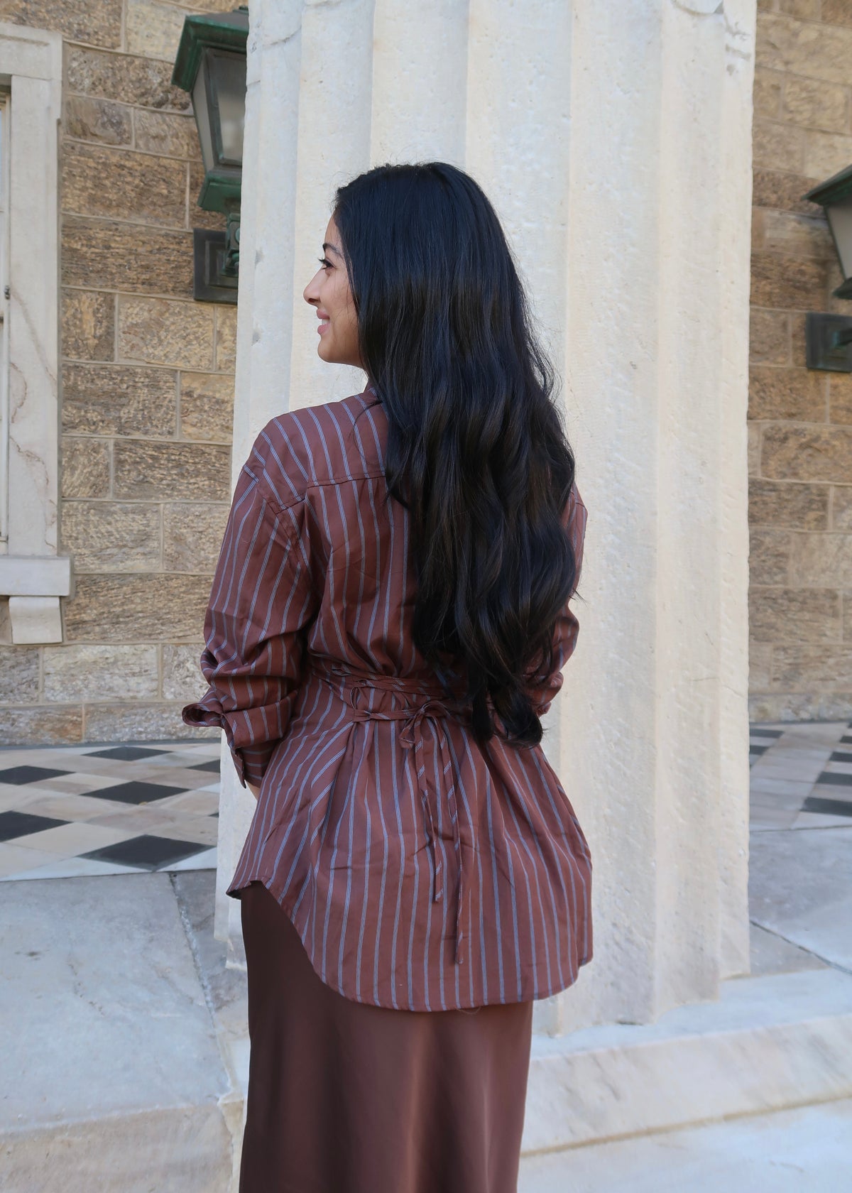 brown and blue striped button down, collared blouse, long sleeve, tie back