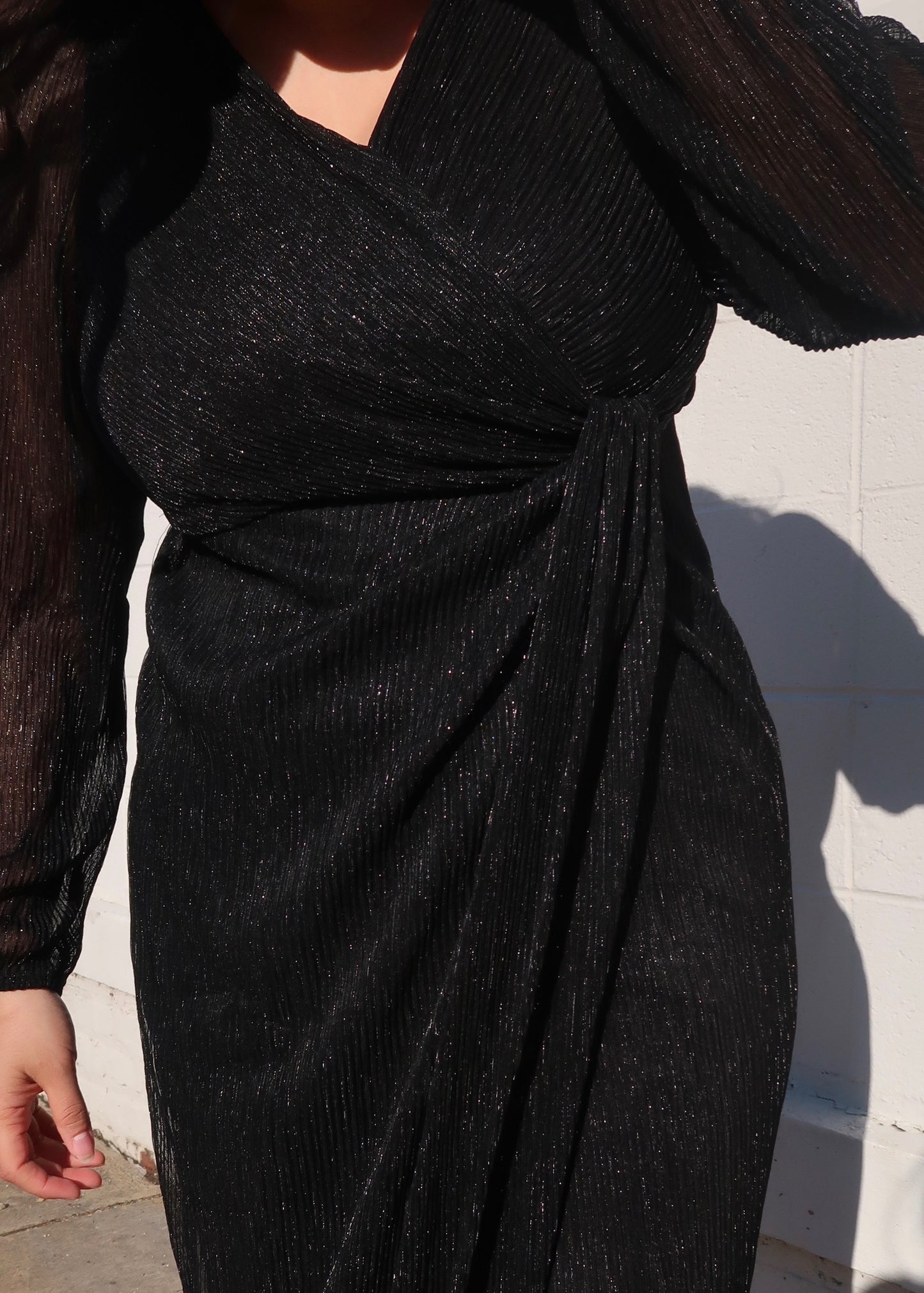 black glittered sparkly sheer sleeve long sleeve dress v neck drap midi length